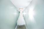 The bride's wedding dress hangs at the Washington Athletic Club (WAC) prior to the start of the wedding at the Seattle Aquarium. (Wedding Photography by Scott Eklund/Red Box Pictures)