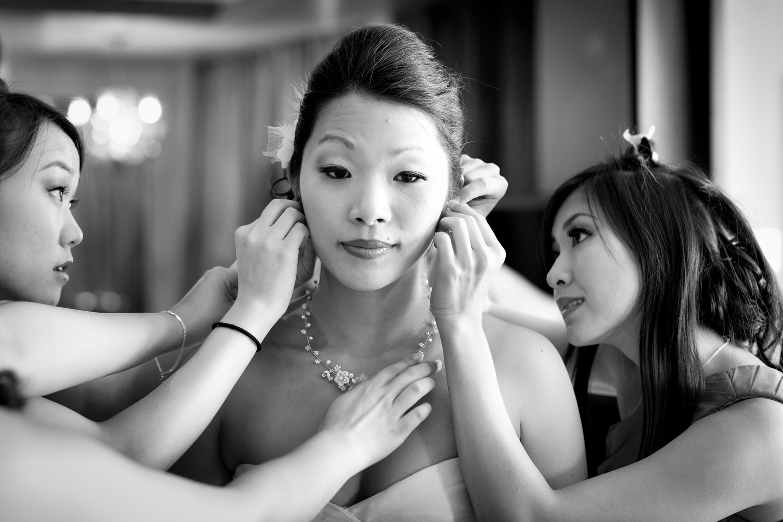 The bride has some last minute touch-up done, with the help of her bridesmaids, at the Washington Athletic Club (WAC) prior to the start of the wedding at the Seattle Aquarium. (Wedding Photography by Scott Eklund/Red Box Pictures)