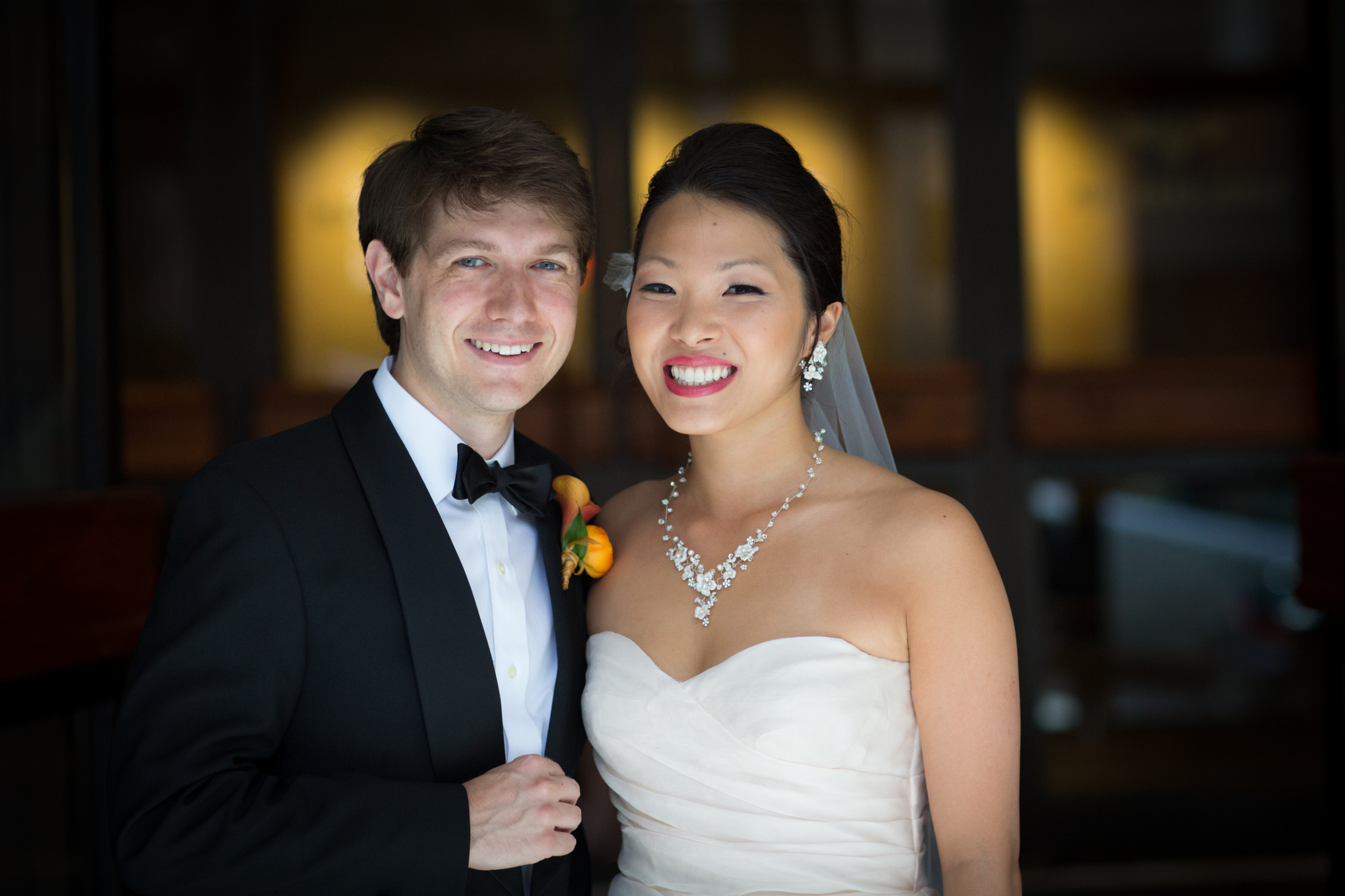 The bride and groom pose for a portrait at the Washington Athletic Club prior to their wedding at the Seattle Aquarium (Photography by Scott Eklund/Red Box Pictures)