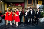 The bridal party hangs out at the Pike Place Market in Seattle prior to the start of the wedding at the Seattle Aquarium. (Wedding Photography by Scott Eklund - Red Box Pictures)