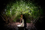 The bride and groom kiss in the woods during their  Cedarbrook Lodge wedding in Seattle, Washington. (Wedding Photography by Scott Eklund - Red Box Pictures)