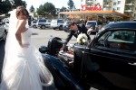 Adrian pretends to inspect the engine of a hot rod parked at Dick's Drive-in in Seattle when they arrived to eat hamburgers prior to their wedding ceremony. (Photo by Scott Eklund/Red Box Pictures)