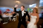 Scott pumps his fist as he and his bride Pauline are introduced at their reception at the Golf Club at Newcastle near Seattle. (Photography by Scott Eklund/Red Box Pictures)