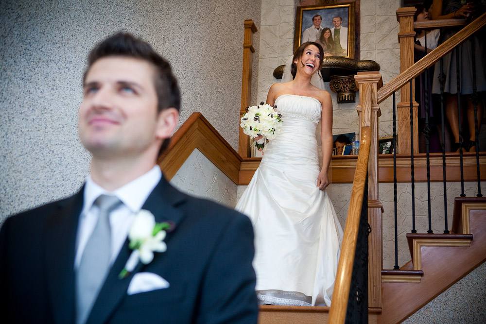 Silvia laughs as she descends a staircase to where Adrian waits to get his first look at her wearing her wedding dress at her Bothell, WA home. (Photo by Andy Rogers/Red Box Pictures)
