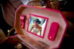 Wearing her wedding dress, Silvia is reflected in the mirror of a makeup case as she finishes getting ready for her wedding at her home in Bothell, WA. (Photo by Scott Eklund/Red Box Pictures)