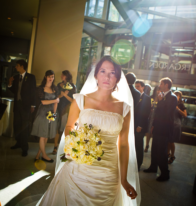 Silvia is bathed in sunlight as she arrives with her wedding party at the lobby of the Hyatt Regency for her wedding reception in Bellevue, WA. (Photo by Scott Eklund/Red Box Pictures)
