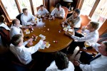 The groom Scott (lower left) plays poker with his groomsmen prior to the start of his wedding at the Golf Club at Newcastle near Seattle.(Wedding Photography by Scott Eklund/Red Box Pictures)