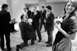 The best man pretends to propose to the bride's brother as the groomsmen joke round during the wedding reception at the Hyatt Regency in Bellevue, WA. (Photo by Andy Rogers/Red Box Pictures)