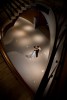 Silvia and Adrian embrace below the winding stairwells at the Hyatt Regency in Bellevue, WA following their wedding reception. (Photo by Scott Eklund/Red Box Pictures)