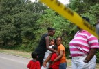 The family of 29-year-old Raymond Smith, who was fatally shot by a Houston police officer, reacts at the scene in the Acres Homes neighborhood of Houston.