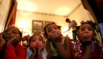 Shawn Powell's children and nieces and nephews watch television to pass the time in their hotel room at the Windsor Suites Hotel in Houston at the end of December 2005. From left are Sah Diamond Lee, 8, Myron Powell, 2, Brittany Powell, 13, and Brishawn Powell, 7.
