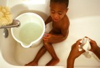 Myron Powell, 2, braves a cold sponge bath in the seventh ward duplex in New Orleans where he lived for two months with his aunt and five cousins. 