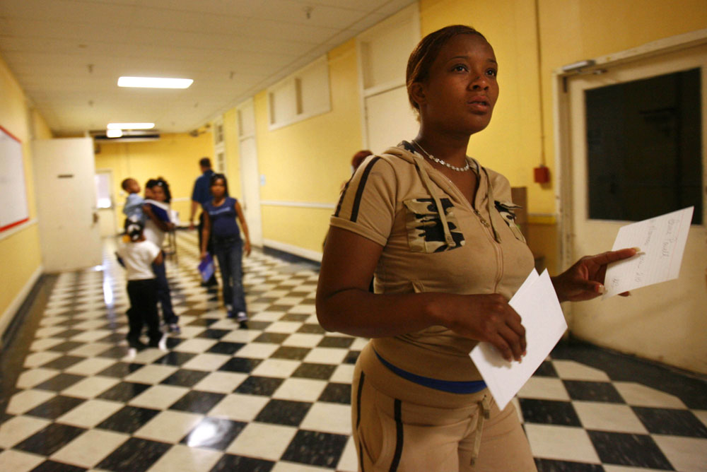 Shawn Powell leads her children to their first day of classes at Craig Elementary School in the sixth ward of New Orleans in mid-March 2006. The kids had been out of school for six months.