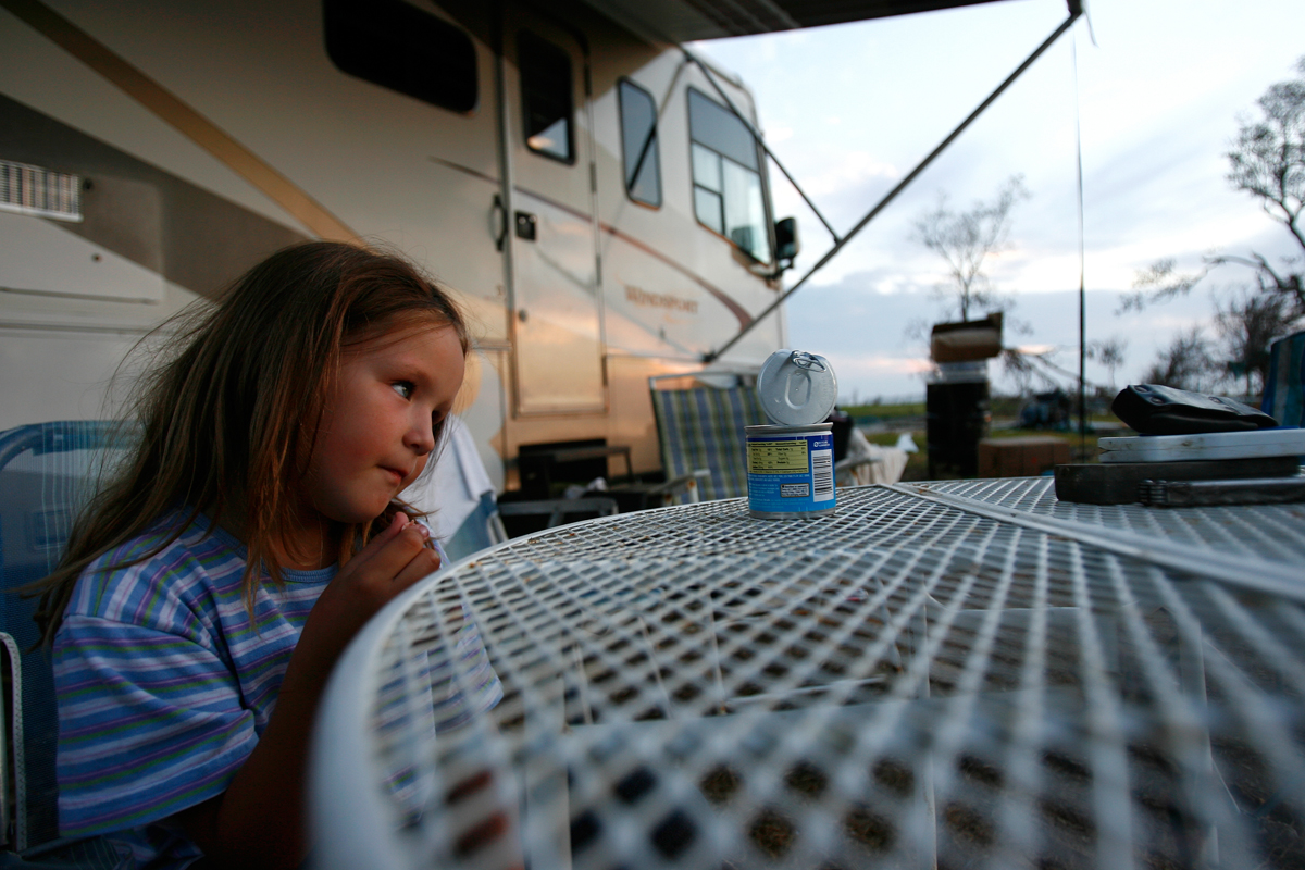  Zoe Key, 6, sits outside her RV in Oak Island.