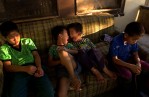 Phillip Bee, 5, center left, makes funny faces with Jerry Xiong, 6, as they relax with their family on their front porch in Marysville, Calif. The porch provided a shady spot for the boys to enjoy the late afternoon as temperatures reached 94 degrees.
