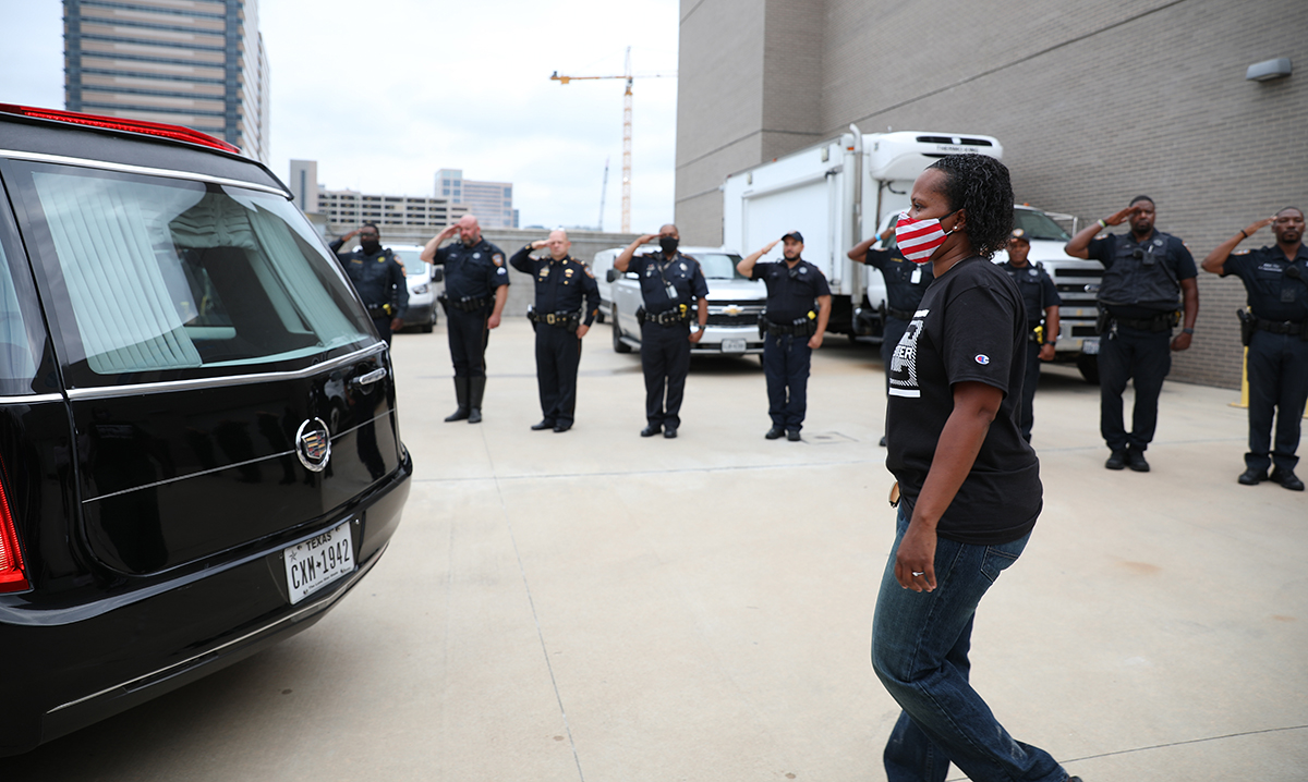 Arsolanda Waters, wife of Deputy Shaun Waters and a sergeant with the City of Southside Place Police Department, walks behind her husband’s hearse during a cordon of honor and procession for Deputy Shaun Waters on August 3, 2021. Waters, a field training officer in Patrol District 4, died of Covid-19 complications on August 1, 2021. 