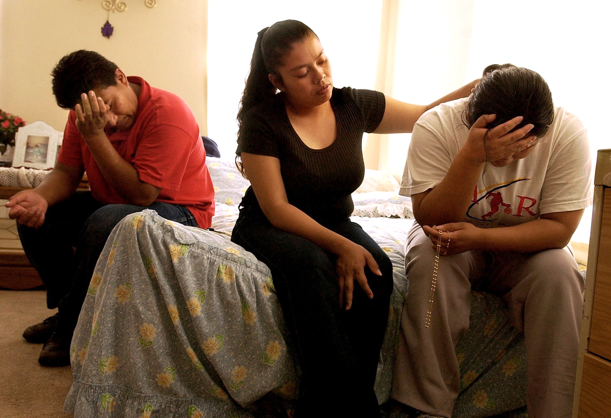 Maria Guadalupe Olalde, far right, mourns the death of her husband with her family in the Dallas, TX home of her in-laws. Her husband, an ice cream vendor, was murdered during a robbery near his ice cream cart in Dallas. Thieves had been targeting the vendors who are mostly undocumented immigrants with no legal recourse.