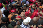 A young boy screams as he is trapped in a mob during a rally for Hugo Chavez in Caracas, Venezuela on Monday, June 11, 2012.