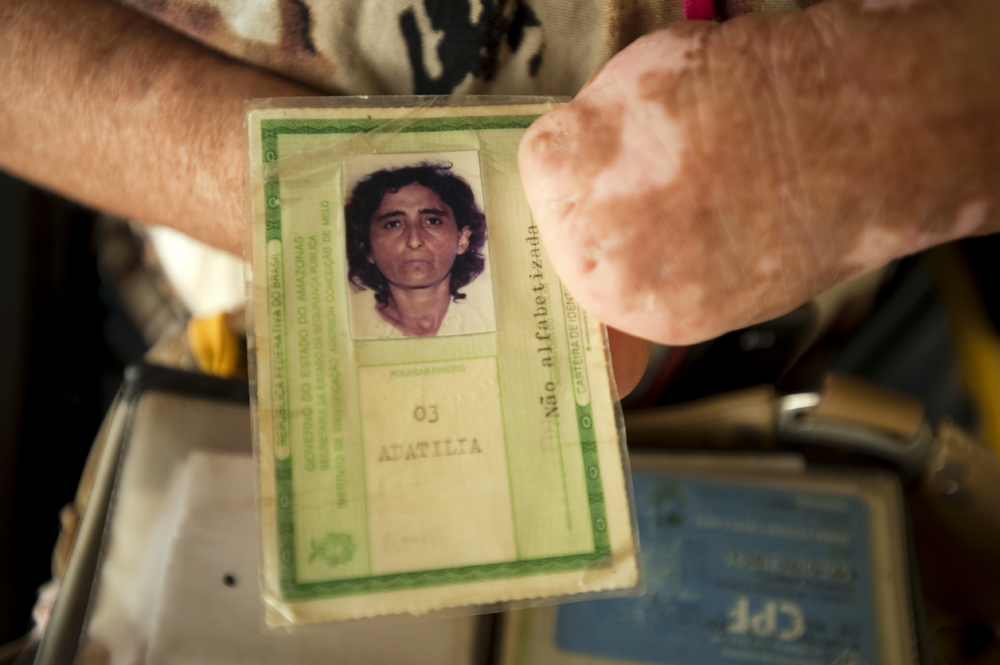 Maria Pereira Cavalcante, 49, holds her identity card. She came to the Antonio Aleixo leprosarium from a remote location in the Amazon.