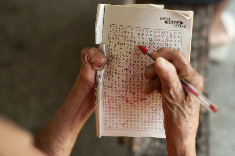 Dalila Matio, 81, stays alert by doing crossword puzzles on Monday, March 12, 2012. She was interned at the now defunct Paricatuba Leprosarium outside Manaus when she was 15 and moved to Colonia Antonio Aleixo in 1966. She met her husband at Paricatuba and they lived together at both leprosariums until they were permitted to leave the grounds for the first time in the late 1960s and live in their own house in the colonia. In 2008, they moved back into the leprosarium. Her husband passed away five years ago.