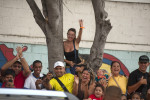 Supporters react as President Hugo Chavez arrives in an SUV to vote at a 23 de Enero neighborhood voting center.