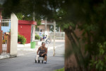  Ira Cema de Souza, 53, moves herself along the main road into the Colonia Antonio Aleixo leprosarium on Monday, March 12, 2012 in Manaus. She came to the leprosarium for treatment from a remote location four days up the Amazon River.