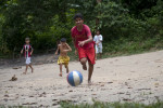 Children play soccer on a makeshift field cleared out of a patch of forest. As Manaus becomes increasingly more urban, people are illegally encroaching into the surrounding forest. People from small towns in the Amazon come to Manaus in search of work. Photographed on Friday, March 16, 2012. 