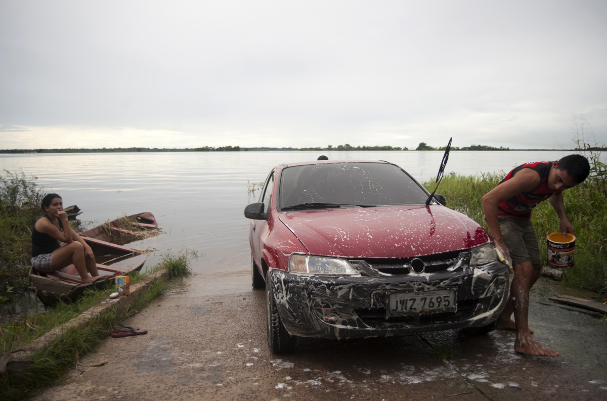 A man washes his car in the Amazon River outside of Manaus.