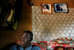 Dennis Arize Ifeachor, Celestina's father, sits in his ancestral home in Urukpaleke near photos of Celestina. He says he sent her with a relative to the United States to attend school and make a better life for herself and her family. 