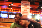 Kentrell Collins, right, the captain of the Prancing Elites, and his boyfriend Derek eat dinner in a Hooters restaurant in Hattiesburg, Miss. in November. The team was on their way back to Mobile after performing in the stands at Jackson State University in Jackson, Miss.