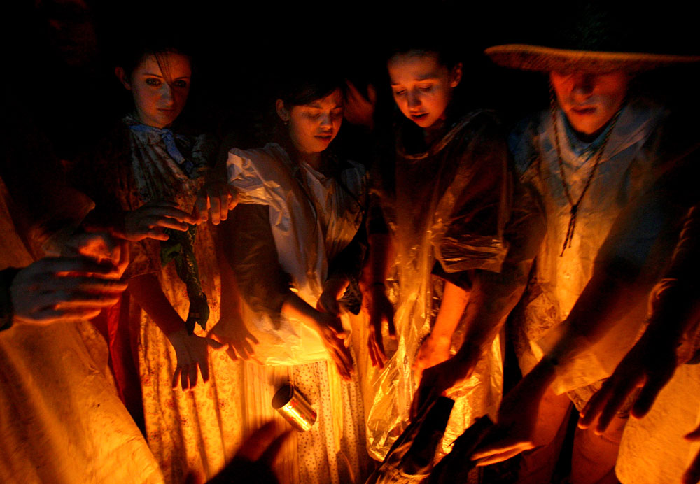 Mormon trekkers try to get warm by the campfire just after arriving for the night after a 6-mile journey in the rain through the Sabine National Forest. They were re-enacting the experience of settlers on the original Mormon trail.  