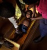 A boyscreams in fear as he is measured by doctors to assess his health. In many African cultures, the only time a person is measured is when it is for a coffin after their death. Parents had to be reassured by staff that doctors were helping their children.
