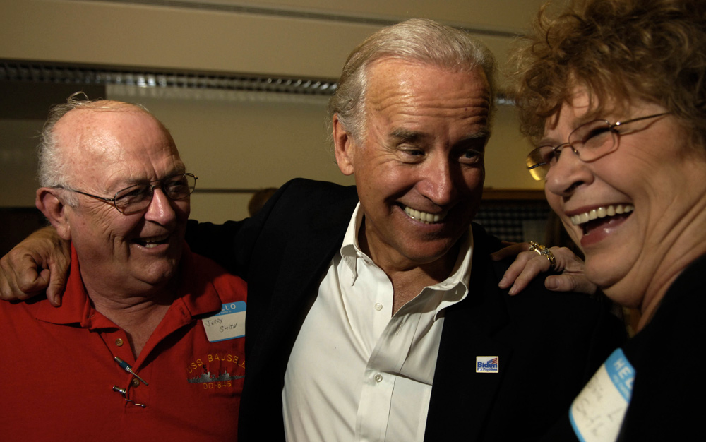 Biden laughs with Jerry Smith and Dixie Smith as they talk outside the conference hall where he addressed the Bremer County Democrats Summer Fundraiser in Waverly, Iowa. Biden is a hands-on politician who enjoys pressing the flesh to try and win support. 