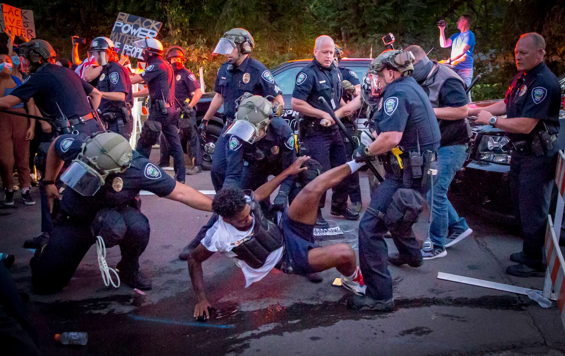 Tyshawn Ford, a leader of Black Unity, is dragged away by Springfield Police Wednesday at a barricade erected by police during a protest by the racial justice group in the Springfield, Ore. July 29, 2020. Ford was charged with disorderly conduct, interfering with police, and resisting arrest.