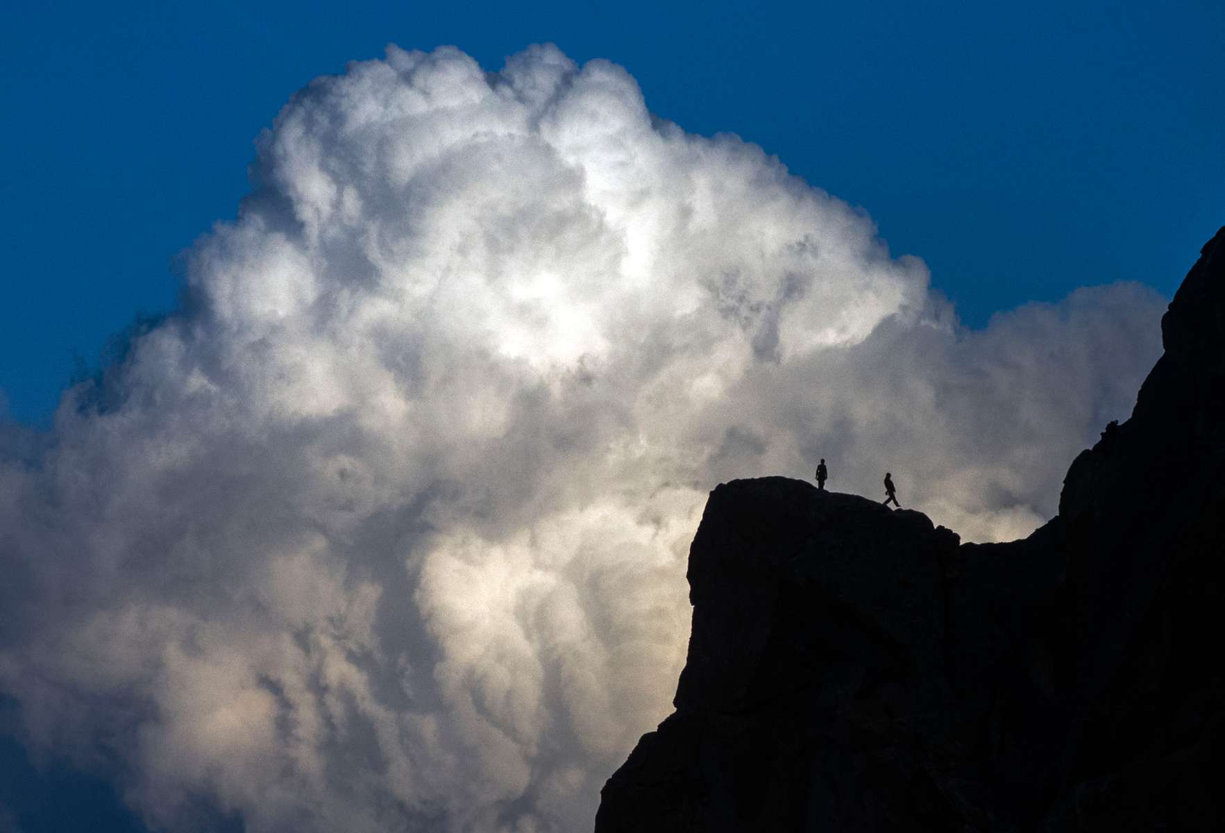 Climbers reach the top of a climbing pitch at Smith Rock State Park as clouds build in Terrebonne on Sunday, October 18, 2015. Smith Rock attracts thousands of visitors each year who climb its vertical walls and spires and enjoy hiking along the Crooked River. (Andy Nelson/The Register-Guard)