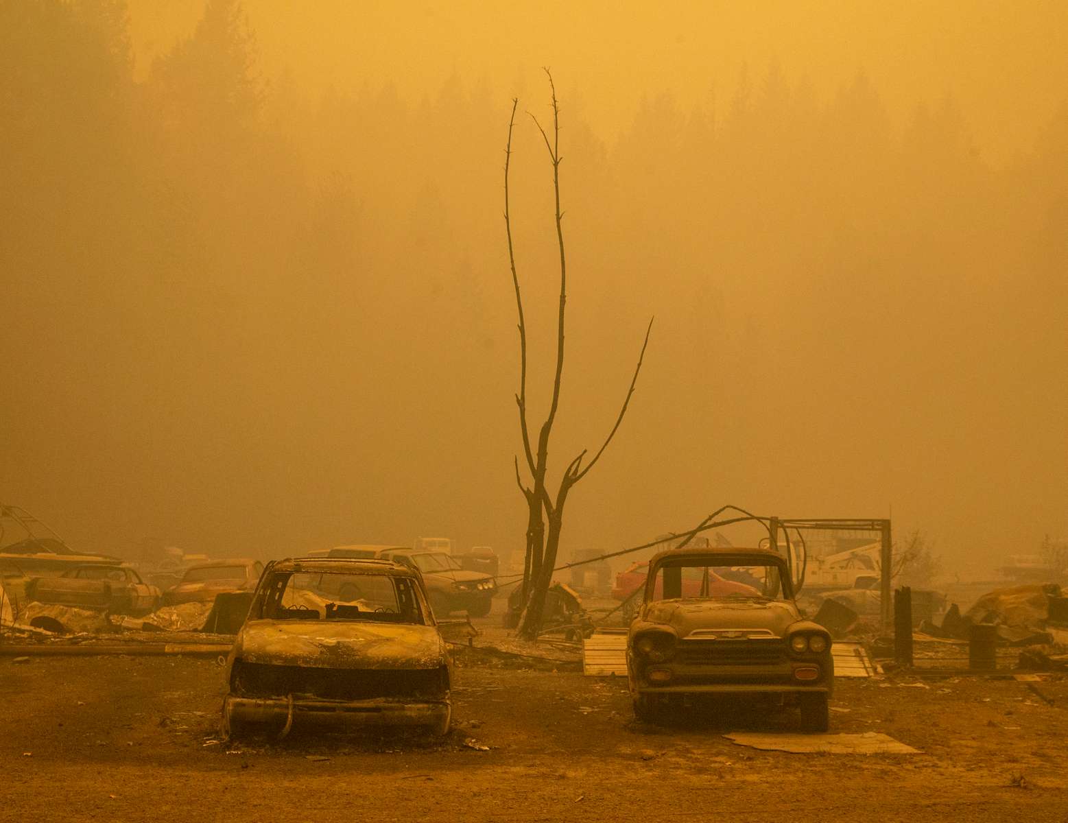 Vehicles burned in the Holiday Farm Fire sit outside a shop in Nimrod, Oregon on September, 10, 2020.