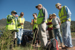 Park Service employee Dyan Harden shows volunteers the type of grass their are to pull on their shift in Rocky Mountain National Park. Volunteers carry out a variety of maintenance tasks under the supervision of park employees.