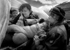 A family rearranges children on their tractor as they flee Kosovo in Albania.