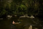 Buckley bathes in a creek near base camp after his first day of field work in the park. They were able to core 8 trees the first day finding trees with rings that likely put the trees older than 500 years. 