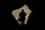 A miner returns to his cave after dumping tailings onto snowfields.