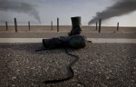 A pair of boots sit on the edge of the highway, abandoned by a deserting Iraqi soldier.
