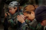 U.S. Marines pray during a Sunday Mass at a field chapel on the way north to Baghdad during the initial invasion into Iraq in 2003. While many in the military are devoted to their faith, the chaplain says the numbers going to services soars when in a combat zone.