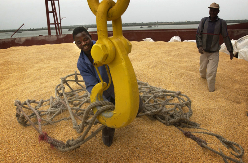 A dockworker in Maputo, Mozambique stands on a hold full of corn shipped from the United States to help eleviate hunger in southern Africa.