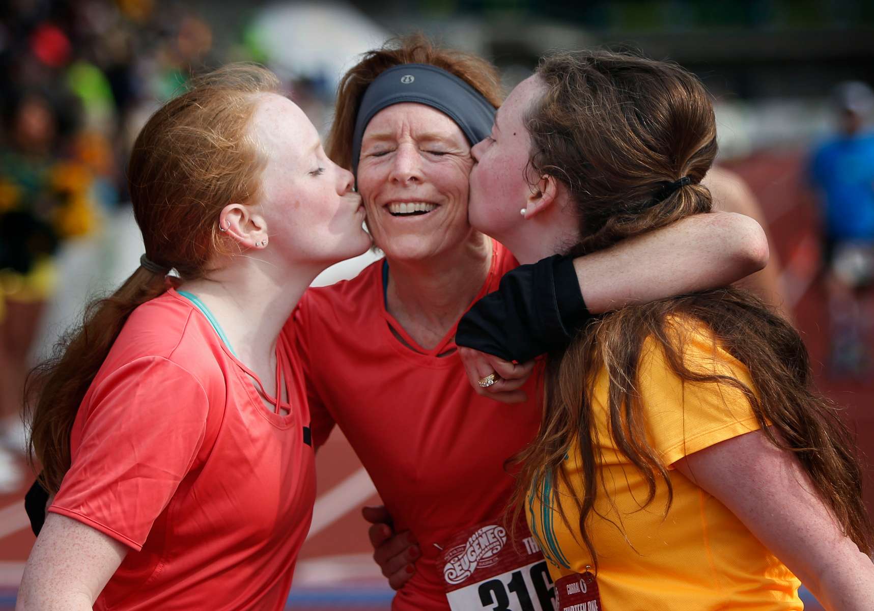 McKay Sohlberg, center, is given a kiss by her daughters, Ericka Sohlberg, left, and Tatum Sohlberg, right, after she completed the 13.1 mile half-marathon at the Eugene Marathon. The event coincided this year with Mother's Day. 