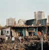 India, Mumbai, February 2008.In Mumbai slums are constantly being demolished to leave room for new hotels, luxury flats and offices of multi national companies to arise. Luxury is popping out as little diamonds spread across this immense city.