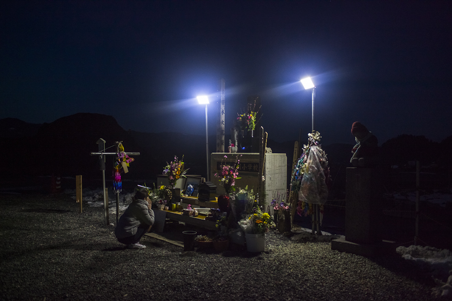 A woman visits a memorial at Okawa Elementary School, near Ishinomaki, Japan, where 77 of 108 students were killed when a tsunami struck the school on March 11, 2011. Japanese citizens traveled from all over the country to visit memorial sites in the tsunami affected region during the one year anniversary. 