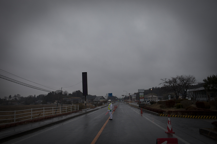 A policeman guards one entrances to a 20 km evacuation zone that surrounds the Fukushima Dai-ichi nuclear plant in Minamisoma, Japan. Radiation is still emitted from the plant, which was damaged during an earthquake and tsunami on March 11, 2011 earthquake and tsunami. Doctors at the nearby Minamisoma City General Hospital claim some 20,000 people, mostly children, are on a waiting list for a newly acquired whole-body counter that can measure their radition levels.