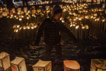 A boy runs between paper lanterns lit to commemorate the one year anniversary of an earthquake and subsequent tsunami that left more than 19,000 people dead or missing. March 12, 2011, Natori, Japan.