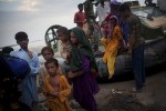 Women deboard a Pakistani Navy hover craft after being rescued from their village. They were then taken to an Army refugee camp, with no idea how long they would have to stay.