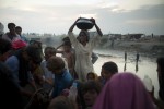 A woman collects water from a pump at a makeshift IDP camp in Kalimuri, Sindh Province, Pakistan, on September 12th, 2010.